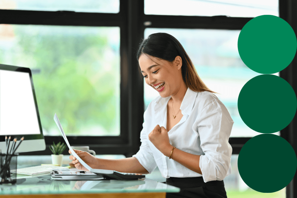 Woman at a desk reviewing a supplier diversity playbook and smiling.