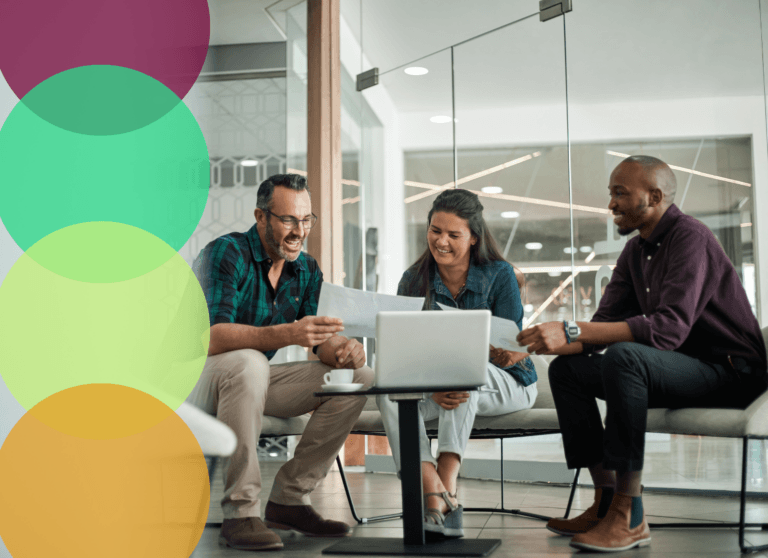 Diverse business professionals reviewing supplier diversity compliance documents together in a modern office.
