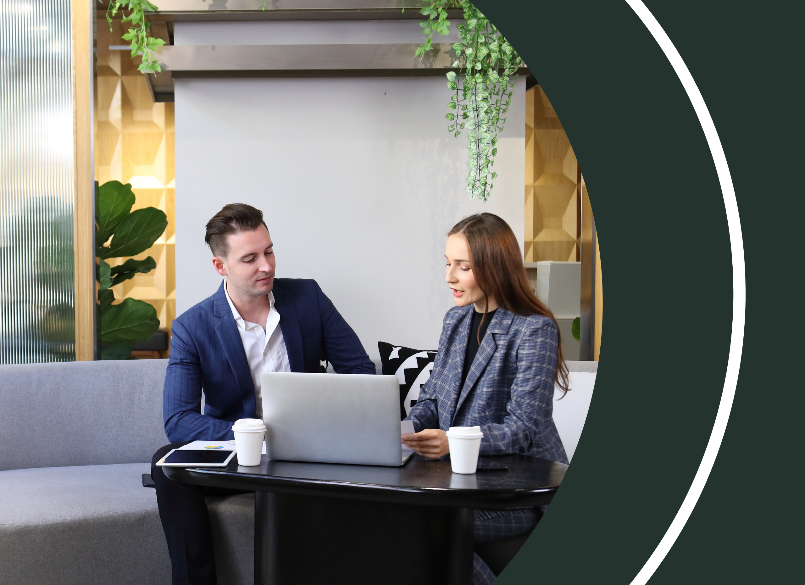 Two procurement professionals reviewing trusted supplier data on a laptop during a strategy meeting.