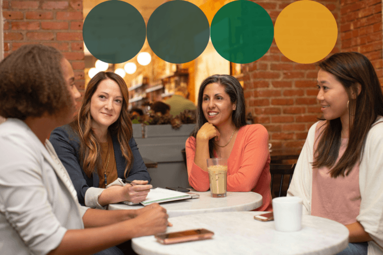 Four women engaged in a collaborative discussion around a table in a warm, casual setting, with dark teal, green, and golden yellow branded circle graphics overlaid along the top of the image.