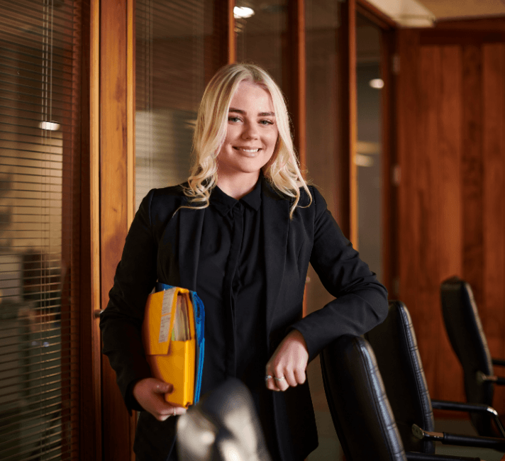 Young office woman holding a file folder.