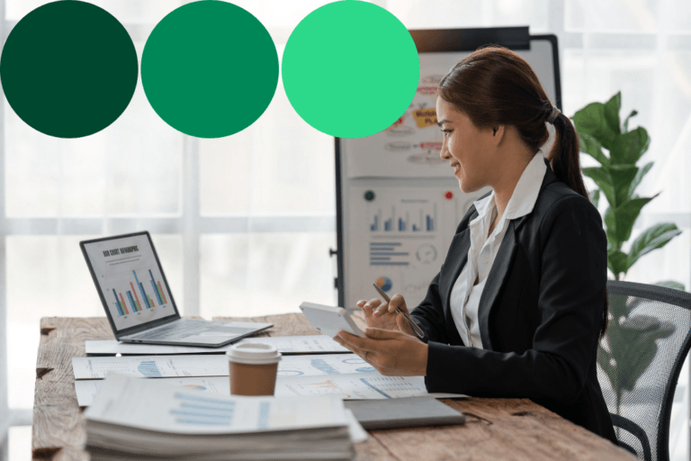 Businesswoman reviewing spend and reporting charts on a laptop and tablet at her desk, with green brand accent circles overlaid.